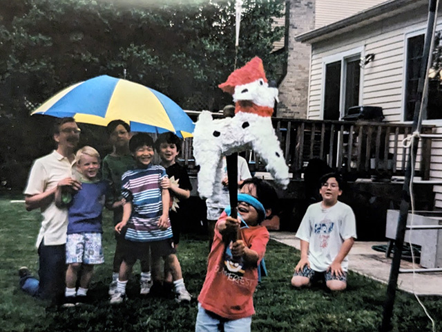Photograph of the author as a young boy hitting a piñata as a promotional piece for the story.